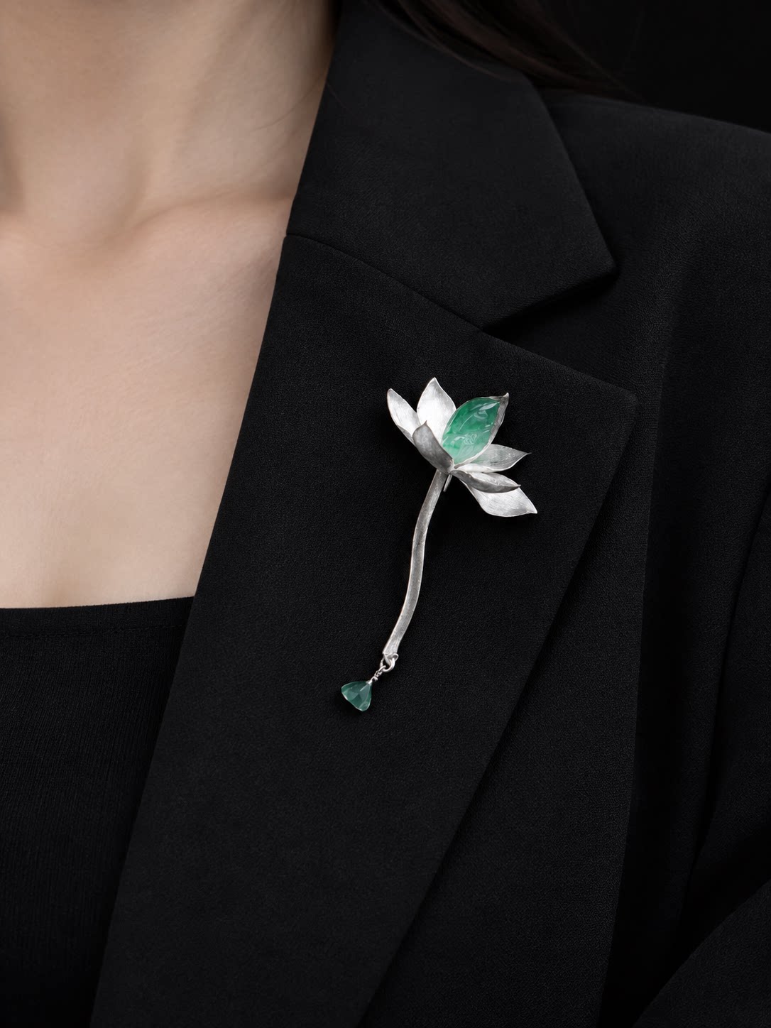 Lotus waterdrop brooch worn on a blazer