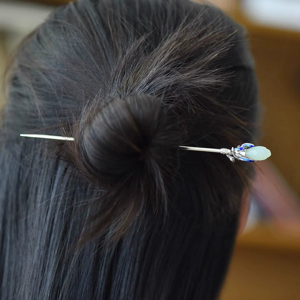 Magnolia hairpin worn in a dark hairstyle