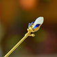 Gold-tone magnolia hairpin with blue floral details