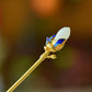 Gold-tone magnolia hairpin with the standard gift box