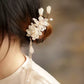 Ivory magnolia hair clip styled with an updo