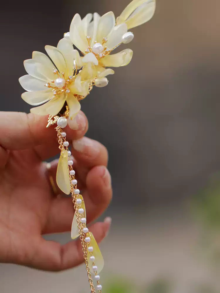 Two-tone magnolia and tassel hair clip close-up