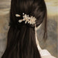 Ivory magnolia tassel side clip styled in a bun