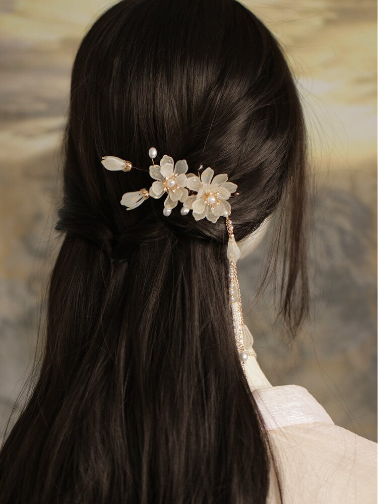 Ivory magnolia tassel side clip styled in a bun