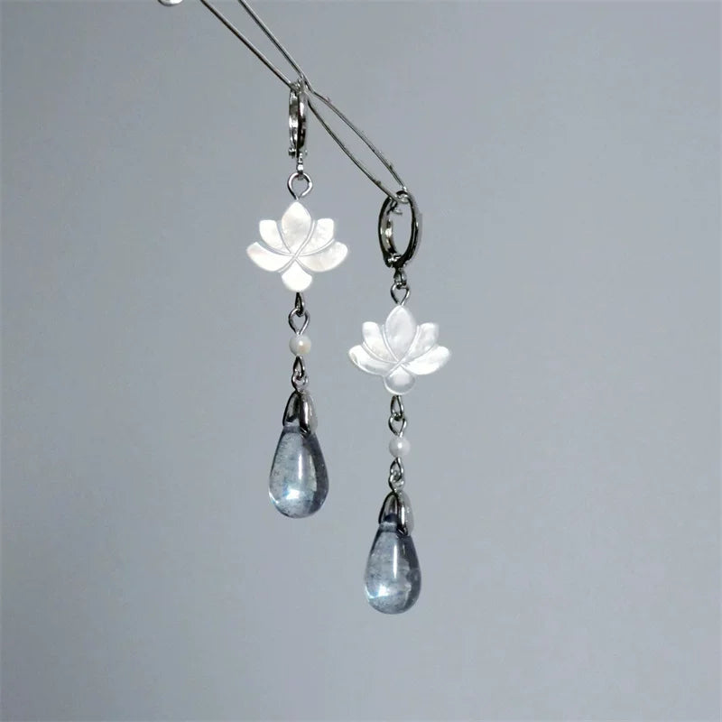 White mother-of-pearl lotus drop earrings with silver-tone hoops and blue-gray teardrop pendants