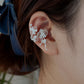 Close-up of the floral ear cuff and clip-on fit