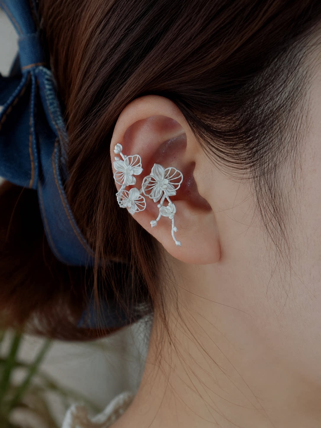 Close-up of the floral ear cuff and clip-on fit