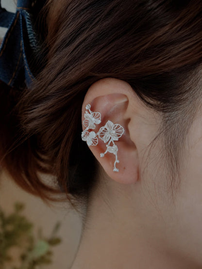 Phalaenopsis orchid copper ear cuff shown worn on the left ear