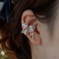 Phalaenopsis orchid copper ear cuff shown worn on the right ear