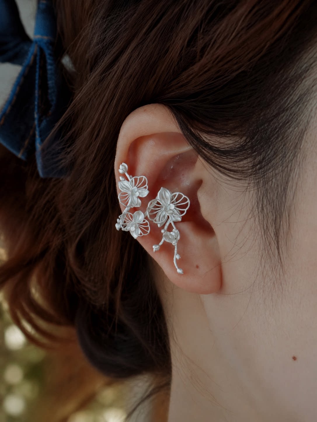 Phalaenopsis orchid copper ear cuff shown worn on the right ear