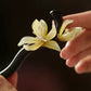 Close-up of an orchid hair stick held in hand
