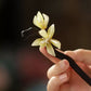 Pale orchid flower detail on a hair stick