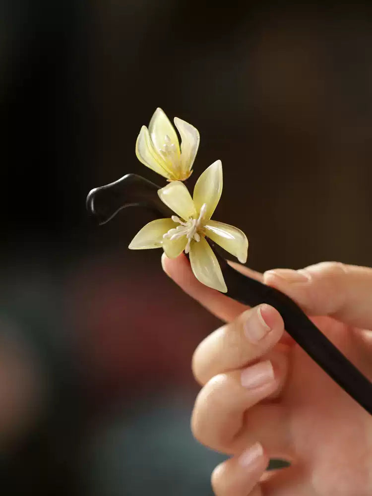 Pale orchid flower detail on a hair stick