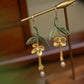 Golden osmanthus flower and green leaf drop earrings, product view