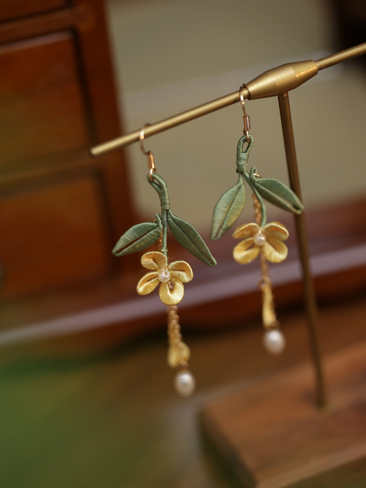 Close product view of the golden osmanthus leaf tassel earrings