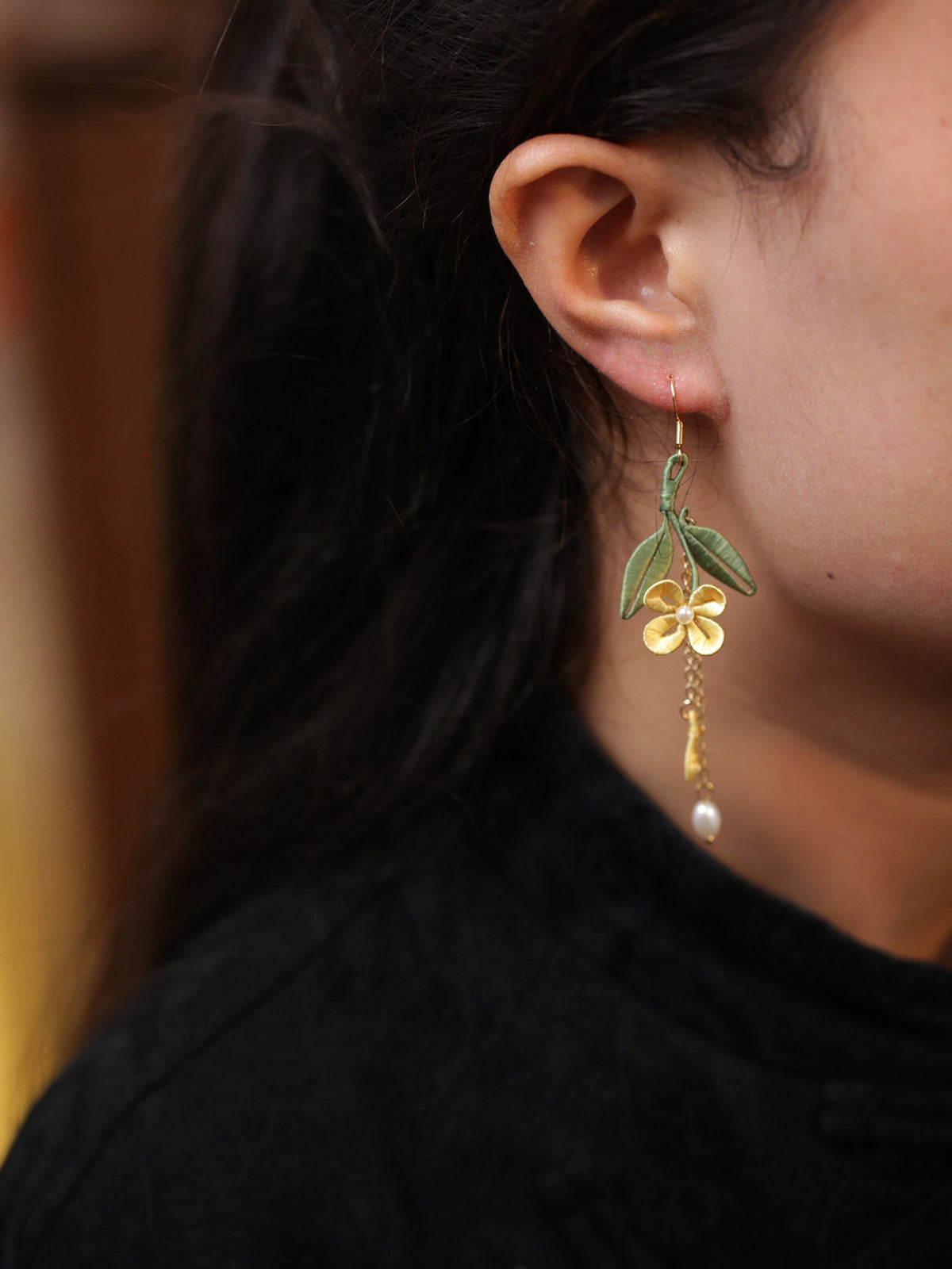 Golden osmanthus leaf tassel earring worn, side view