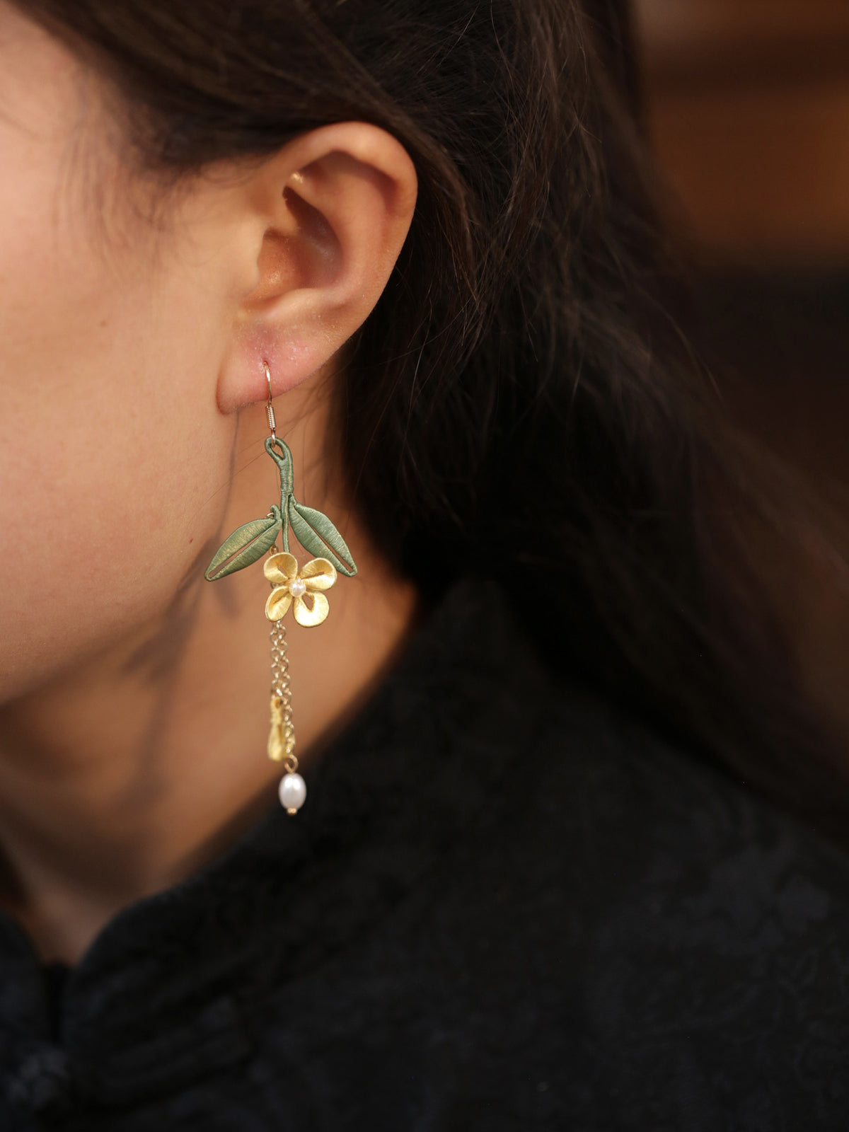 Golden osmanthus flower and green leaf tassel earrings, detail view