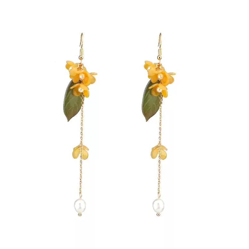 Pair of long osmanthus flower and white bead drop earrings on a white background
