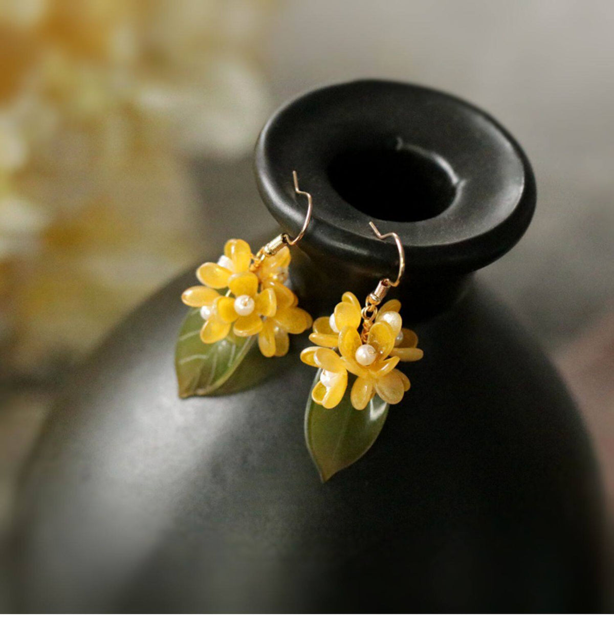 Close product view of the short golden osmanthus flower earrings with white accents