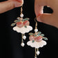 Close view of peach-shaped drop earrings
