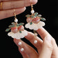 Pair of peach drop earrings, close-up