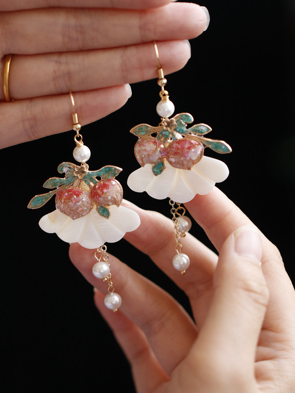 Pair of peach drop earrings, close-up