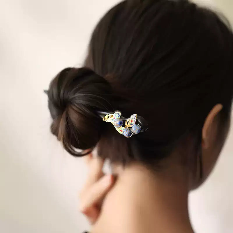 Peacock-inspired hairpin styled in an updo