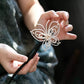 Side view of an openwork pearl butterfly hairpin