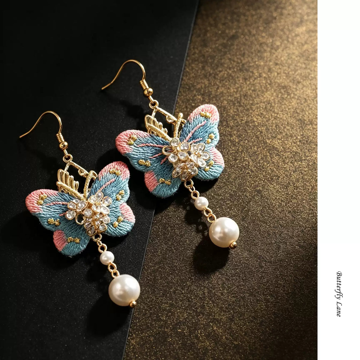 Pink and blue embroidered butterfly drop earrings with pearl-style dangles, pair