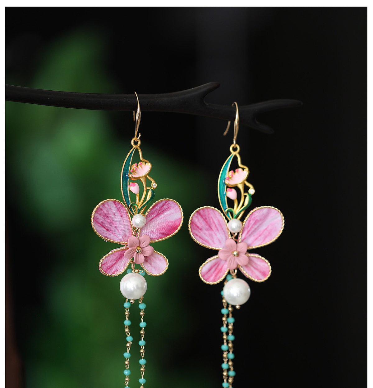 Close-up of the pink butterfly and floral earring design