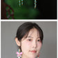 Editorial detail showing the earring design and styling