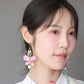 Model wearing a pink butterfly dangle earring