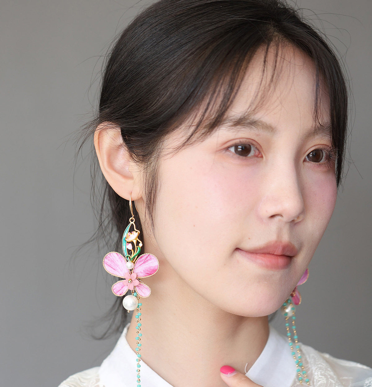Model wearing a pink butterfly dangle earring