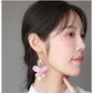 Side view of the pink butterfly earring worn