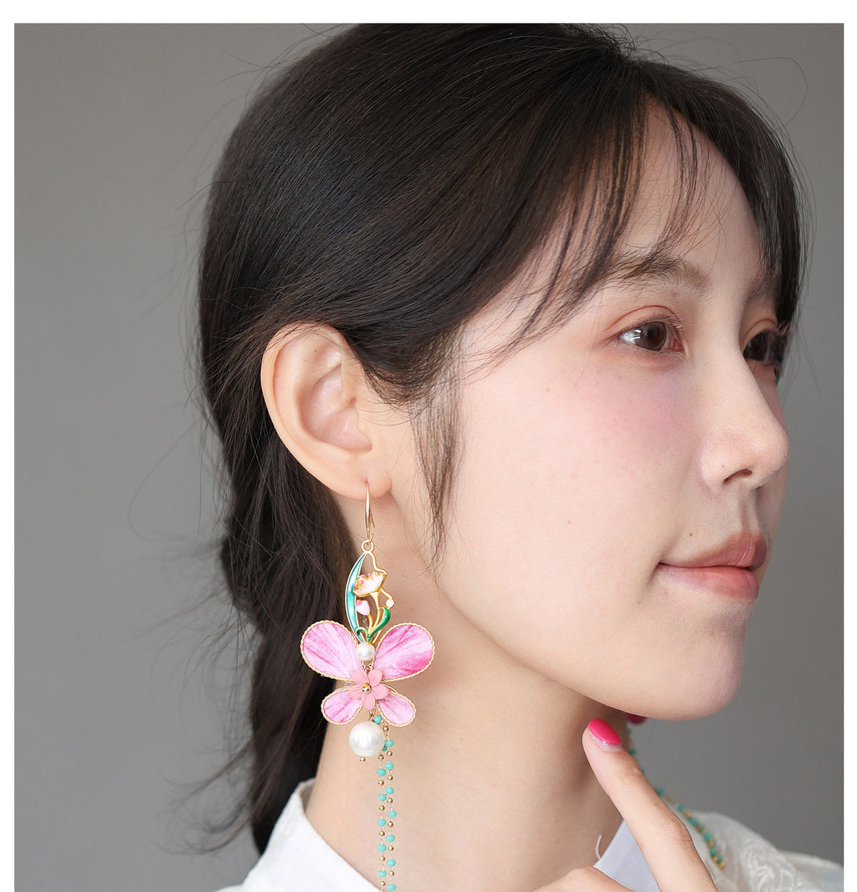 Side view of the pink butterfly earring worn