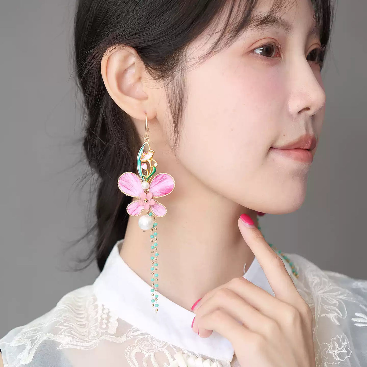 Side view styling of pink butterfly dangle earrings