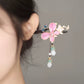 Pink butterfly floral hairpin worn in an updo