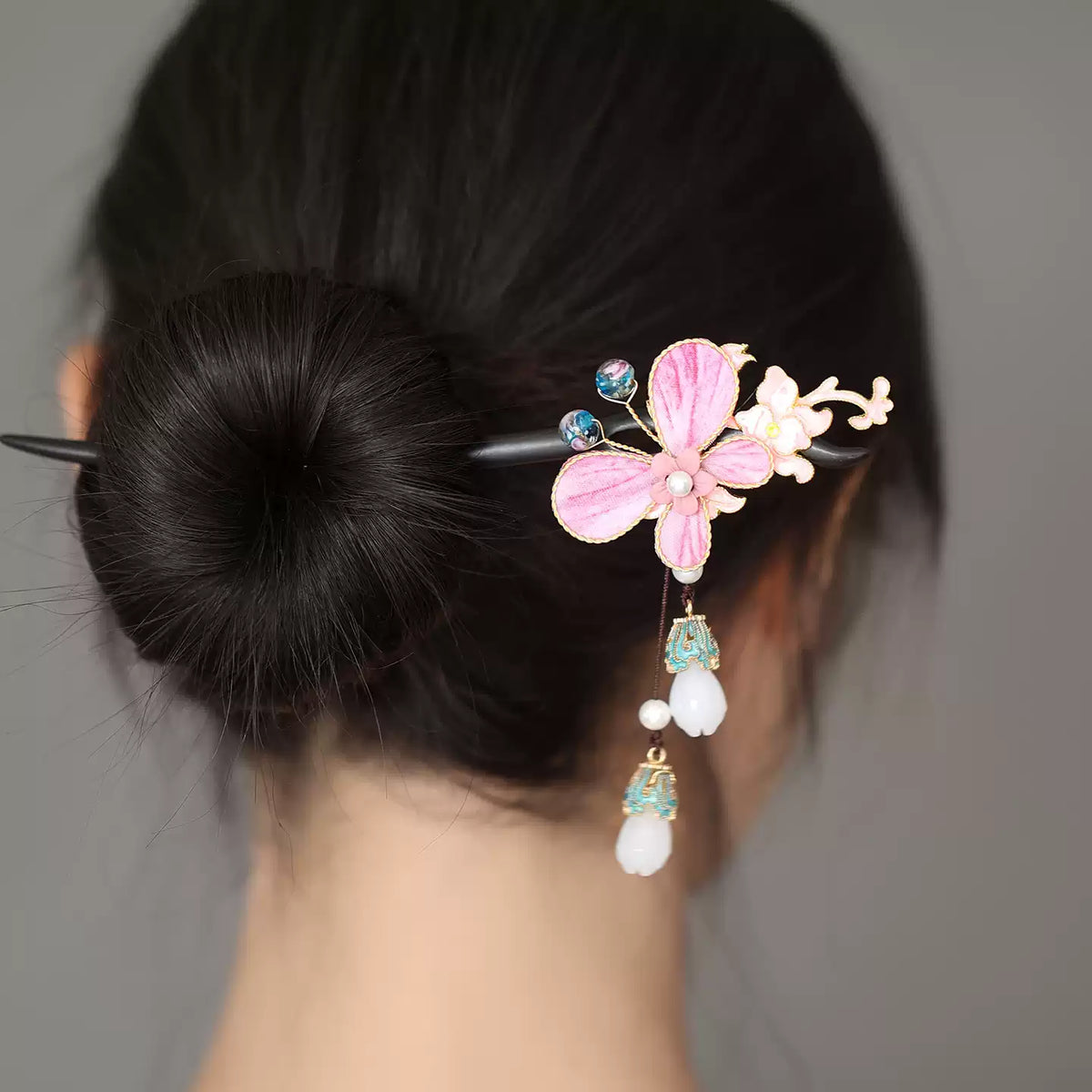Side view showing the dangling ornaments on the floral hairpin