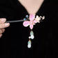 Close-up of the pink butterfly ornament and long dangling drops