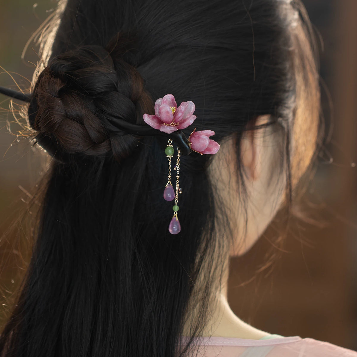 Chinese-inspired floral tassel hairpin worn in a hairstyle
