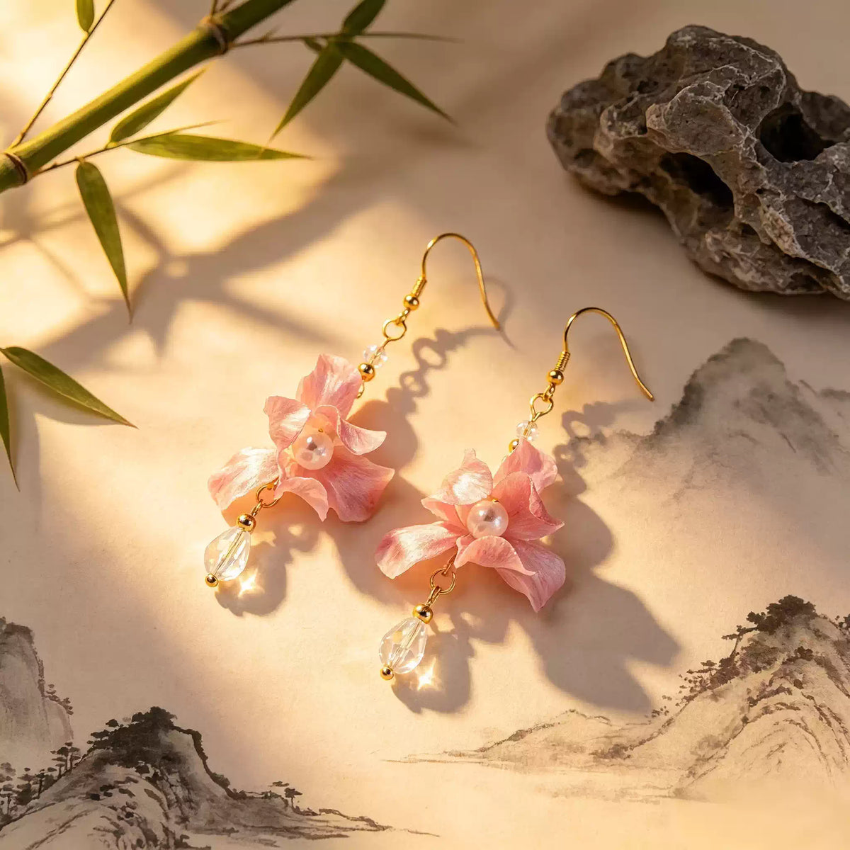 Pink iris flower drop earrings in a softly lit scenic display