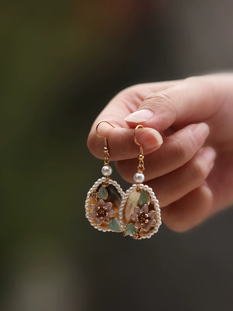 Pink floral drop earrings with faux pearl frames and gold-tone findings