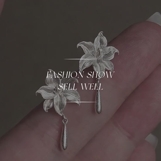 Product video showing the lily flower copper stud earrings with drop details