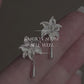 Product video showing the lily flower copper stud earrings with drop details