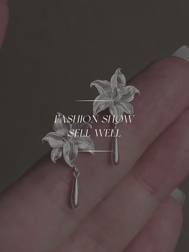 Product video showing the lily flower copper stud earrings with drop details