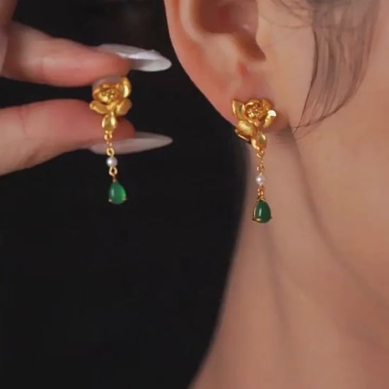 Product video showing the gold-tone lotus-style drop earrings with green accents