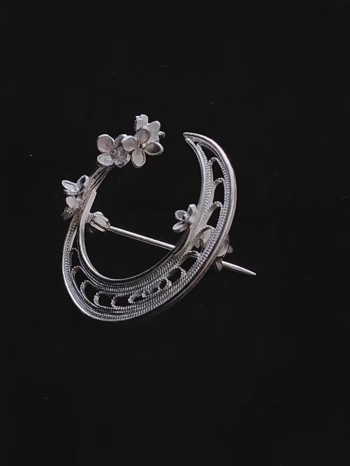 Product video showing the silver-tone copper crescent moon floral brooch