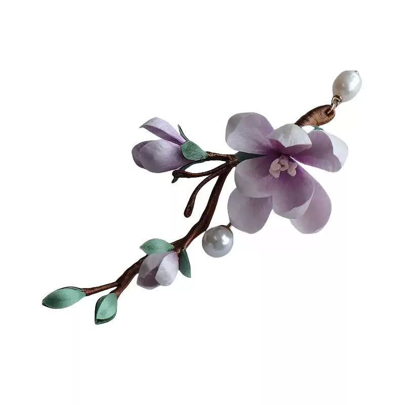 Purple floral branch brooch isolated on a white background