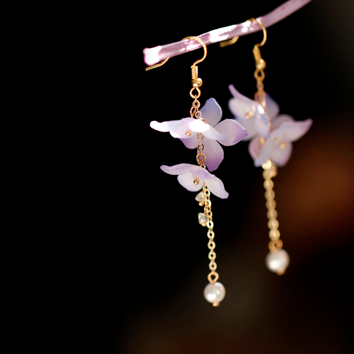 Long purple floral earrings with pale drop accents