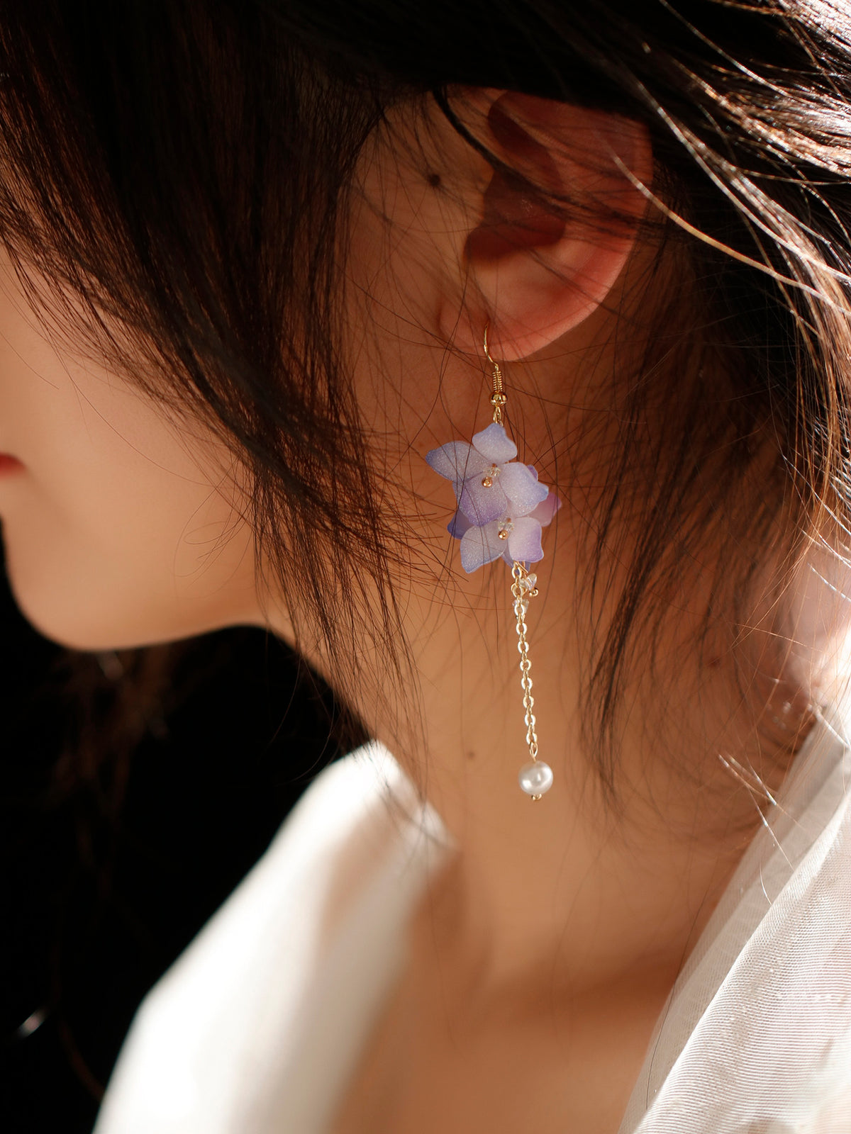 Purple hydrangea earrings worn, close-up view